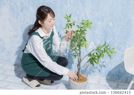 A woman with a smile wearing an apron 136682415