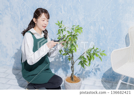 A woman with a smile wearing an apron 136682421