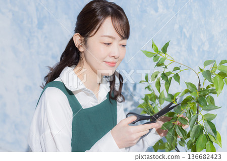 A woman with a smile wearing an apron A woman with a smile wearing an apron 136682423