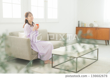 Woman drinking tea in the living room 136682678
