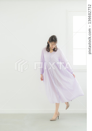A woman in a lavender dress 136682752