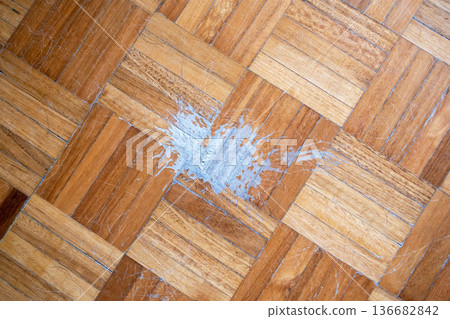 Paint spill on a wooden parquet floor Paint spill on a wooden parquet floor 136682842