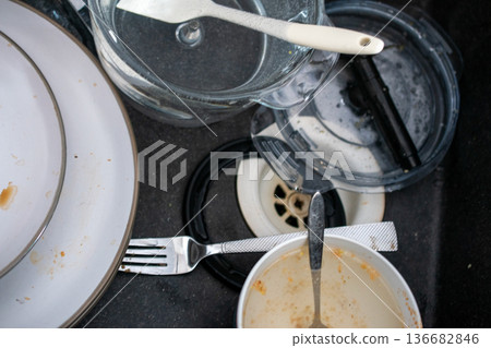 A Pile of Dirty Dishes in a Kitchen Sink A Pile of Dirty Dishes in a Kitchen Sink 136682846