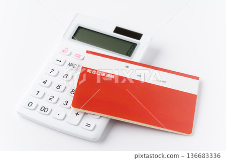 Calculator and bankbook on white background 136683336