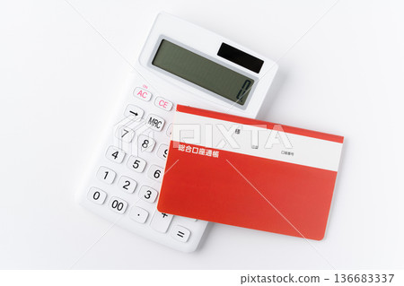 Calculator and bankbook on white background Calculator and bankbook on white background 136683337