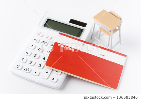 A calculator, bankbook, and miniature school desk and chair on a white background 136683846