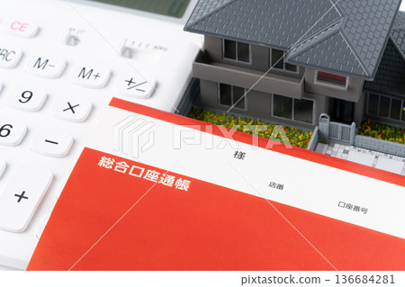 Calculator, bankbook and miniature detached house Calculator, bankbook and miniature detached house 136684281