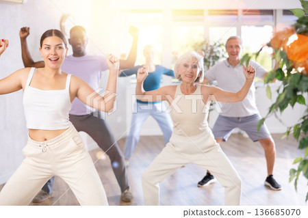 Young girl dancing hip hop in group dance class for adults Young girl dancing hip hop in group dance class for adults 136685070