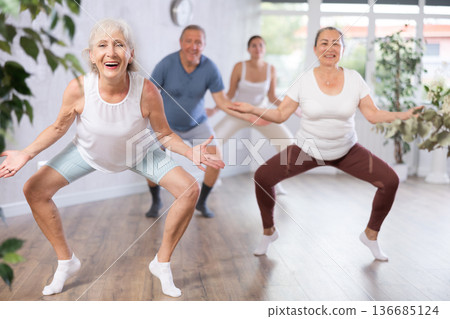 Mature woman with visitor actively moves and learns to dance hip hop Mature woman with visitor actively moves and learns to dance hip hop 136685124