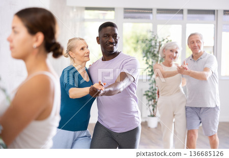 African American man dancing slow dance with aged woman African American man dancing slow dance with aged woman 136685126