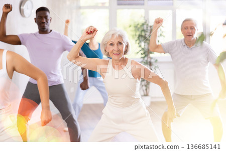 Senior woman learning to dance krump in modern choreographic studio 136685141