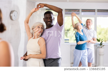 Group of multiethnic mature people dancing social dance 136685195