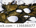 The flow of the Ezawa River and snow-covered stones 136686077