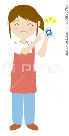 A woman wearing an apron navigating a website on her smartphone 136686760