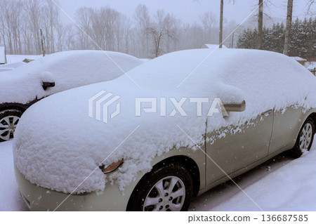 Cars covered in snow during winter storm in residential area Cars covered in snow during winter storm in residential area 136687585