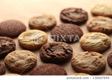 A photo of cookies with soft shadows taken against a warm background 136687640
