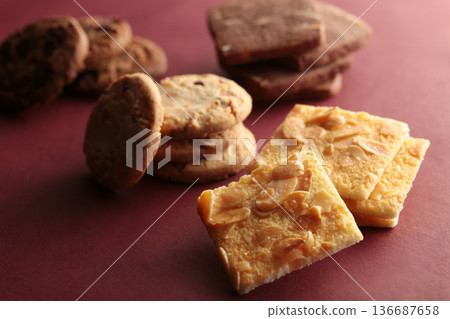 A photo of cookies with soft shadows taken against a warm background 136687658