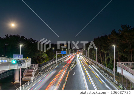 Light trails of passing cars taken from a pedestrian bridge at night 136687725