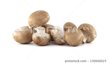 Pile of fresh brown cremini mushrooms with white stems on a clean white background Pile of fresh brown cremini mushrooms with white stems on a clean white background 136688025