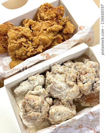 Crispy Korean fried chicken, perfectly glazed with a sweet and spicy sauce. Ideal for food photography and menus, showcasing the irresistible crunch and flavor of this beloved dish. 136688597