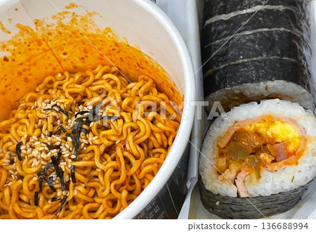 Kimbap and Ramyun, a perfect Korean combo! Enjoy savory rice rolls with vegetables, meat, and pickles alongside a flavorful bowl of spicy, comforting ramen. A satisfying meal for any time of day. 136688994