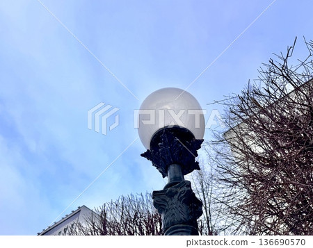 urban white street lamp on the background of the blue sky in winter. High quality photo 136690570