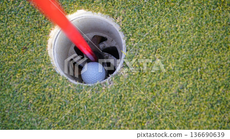Selective focus. white golf ball in hole on green grass good for background. 136690639