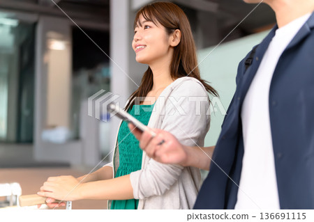 A man and woman traveling together checking information. Photo courtesy of Kansai International Airport (KIX) A man and woman traveling together checking information. Photo courtesy of Kansai International Airport (KIX) 136691115