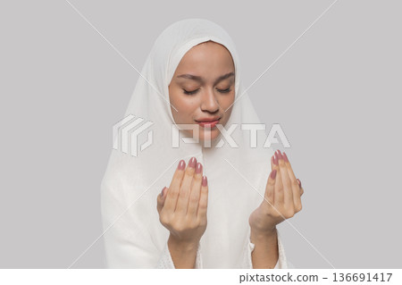 Female subject in soft lighting displays thankful mood through warm smile and calm demeanor Female subject in soft lighting displays thankful mood through warm smile and calm demeanor 136691417