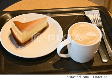 Blissful cafe time: Rich cheesecake and latte art Blissful cafe time: Rich cheesecake and latte art 136691840