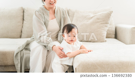 Mother playing with baby in the living room at home (single mother, single parent, single-parent household) Mother playing with baby in the living room at home (single mother, single parent, single-parent household) 136692380