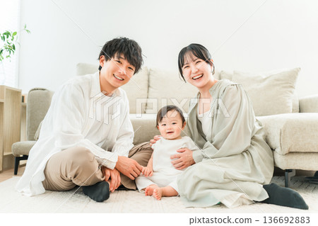 Parents and children playing with their babies in the living room, family, couple Parents and children playing with their babies in the living room, family, couple 136692883