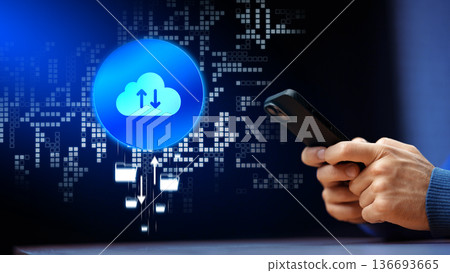 Using a smartphone to upload data to the cloud at night with digital graphics in the background Using a smartphone to upload data to the cloud at night with digital graphics in the background 136693665