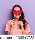 Woman standing her smile confidence cheerful cheery girl holding in hands two red heart symbol cards closing eyes isolated white background, Asian happy portrait beautiful young female valentine. 136693788