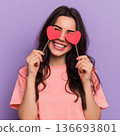Woman standing her smile confidence cheerful cheery girl holding in hands two red heart symbol cards closing eyes isolated white background, Asian happy portrait beautiful young female valentine. 136693801