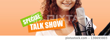 Podcast host speaks into microphone during a lively session at a studio 136693803