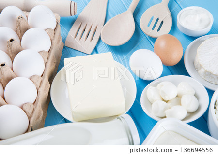 dairy products on blue wooden background, top view 136694556