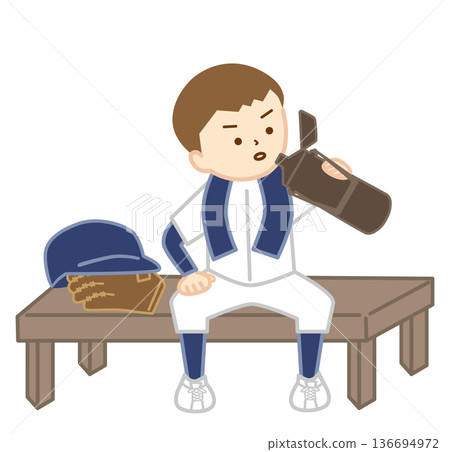 A baseball boy sitting on a bench with a towel around his neck hydrating A baseball boy sitting on a bench with a towel around his neck hydrating 136694972