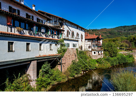 Walking through the streets of Elizondo, Navarra, Spain. Traditional Basque houses with classic red and white facades 136695297