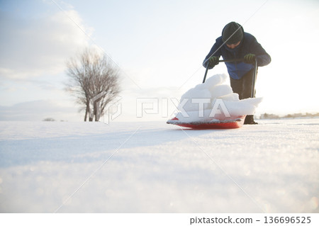 Clearing snow with a snow dump Clearing snow with a snow dump 136696525