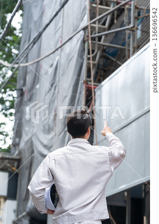 Men in work clothes outdoors scaffolding 136696542