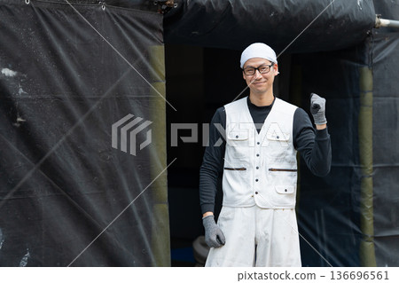 Men in work clothes, knickerbockers, fist pump Men in work clothes, knickerbockers, fist pump 136696561