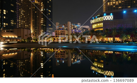 City skyline at night with illuminated buildings and water reflection 136697089