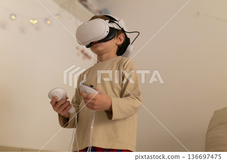 Young boy exploring virtual reality gaming experience 136697475