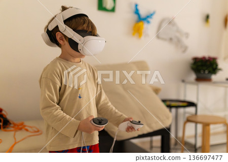 Young boy playing a virtual reality game at home Young boy playing a virtual reality game at home 136697477