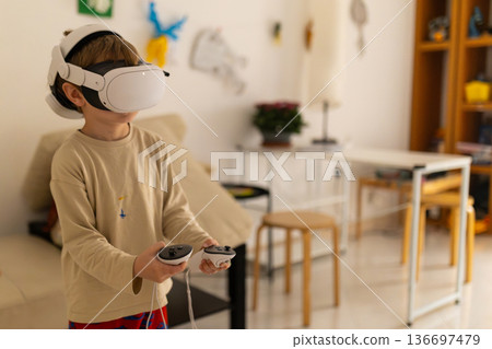 Child wearing virtual reality headset playing immersive game Child wearing virtual reality headset playing immersive game 136697479