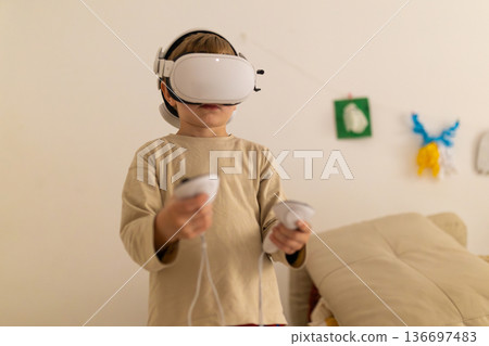 Young boy experiencing virtual reality playing immersive game Young boy experiencing virtual reality playing immersive game 136697483