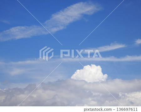 Cumulus clouds rising from below 136697611