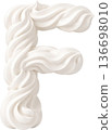 The letter F formed from swirling piped white cream or frosting 136698010