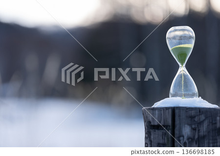 Snowy landscape and hourglass Snowy landscape and hourglass 136698185